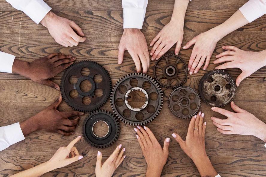 Hands holding mechanical wheels